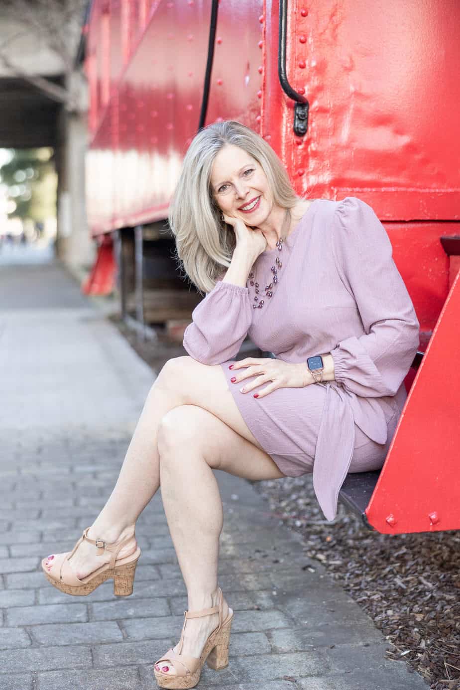 Jeanette Shorey sitting on a red caboose